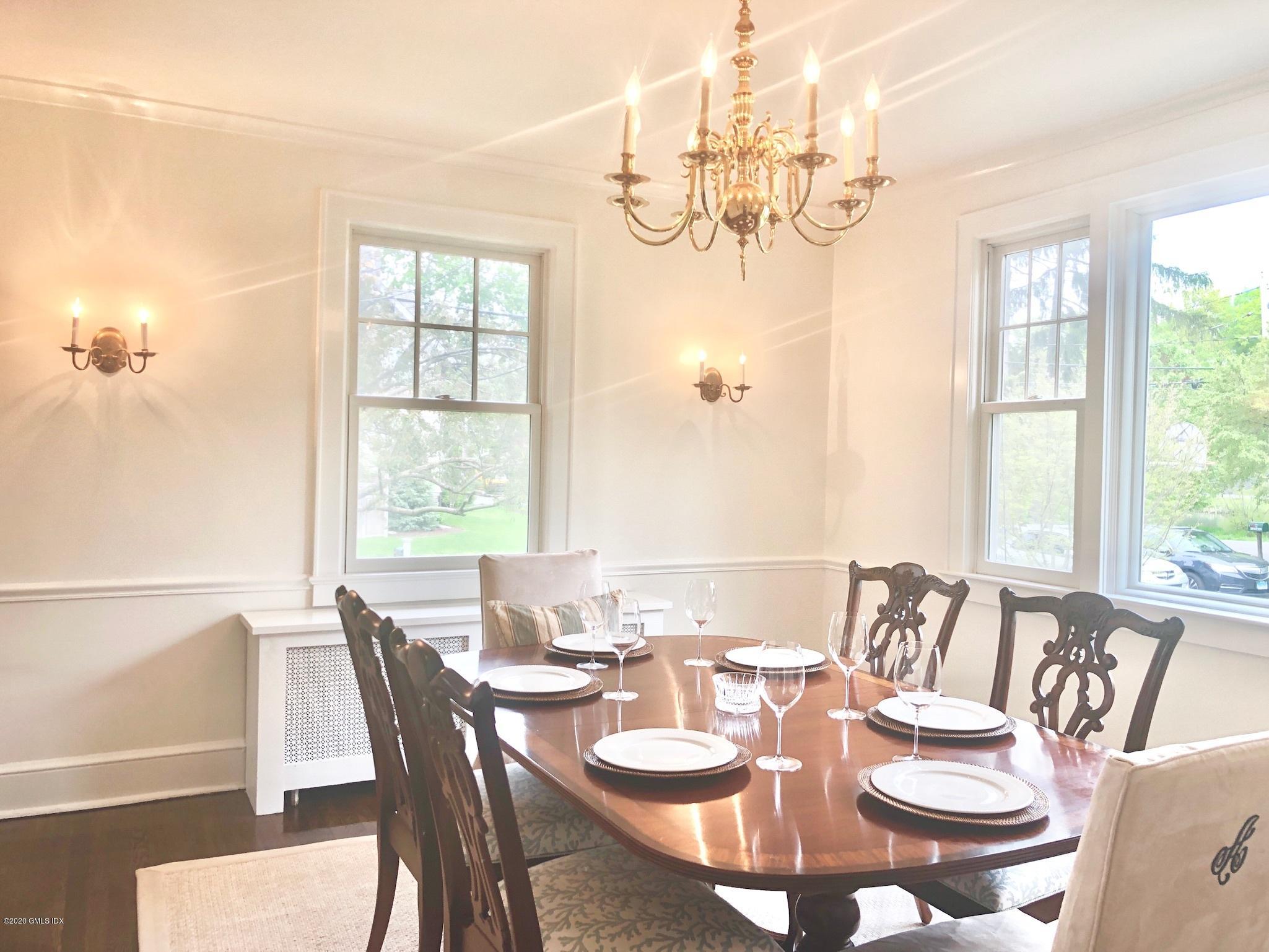 10 Lake Drive South, Unit SOUTH Riverside, CT 06878 - Photo 24 of 45 a view of a dining room with furniture a chandelier and large windows