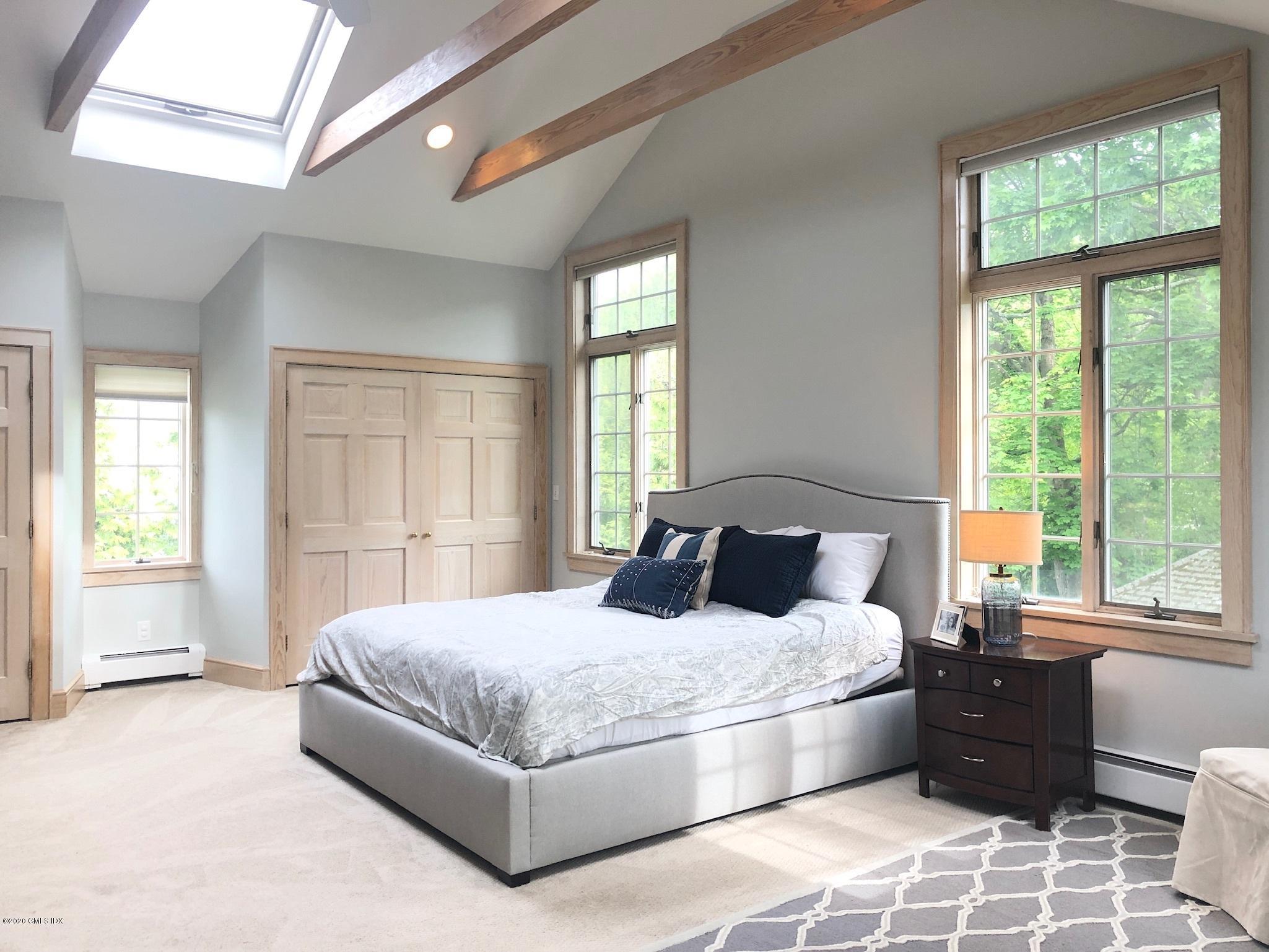 10 Lake Drive South, Unit SOUTH Riverside, CT 06878 - Photo 26 of 45 a bedroom with a large bed and a large window