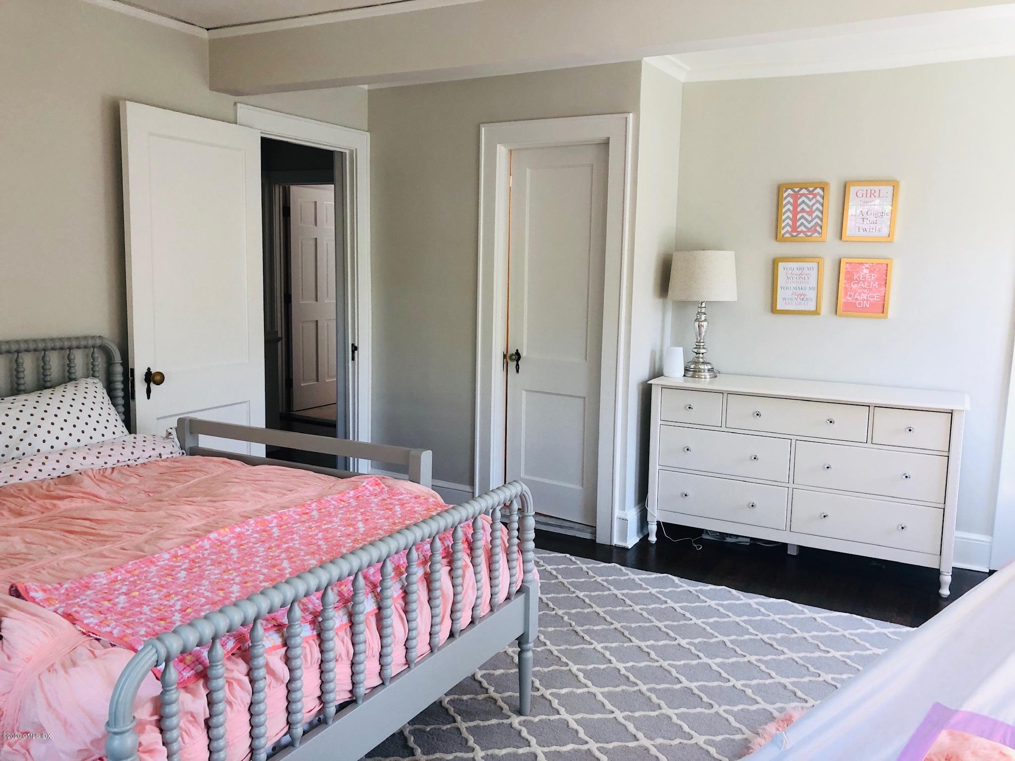 10 Lake Drive South, Unit SOUTH Riverside, CT 06878 - Photo 28 of 45 a bedroom with a bed a dresser and painting