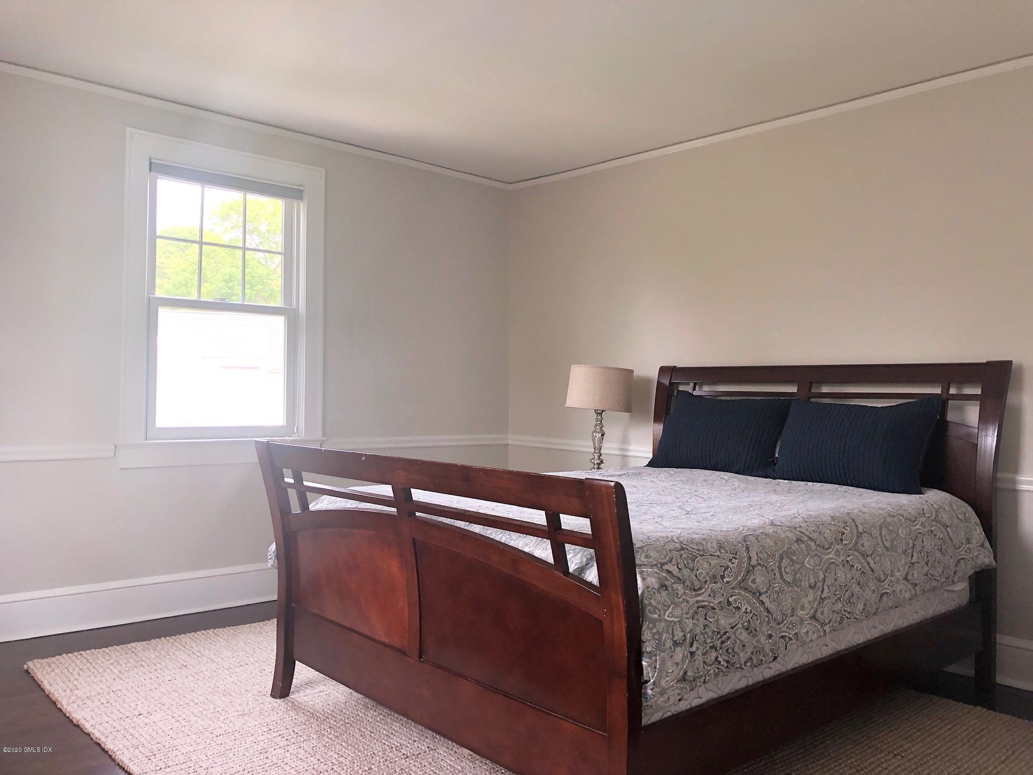 10 Lake Drive South, Unit SOUTH Riverside, CT 06878 - Photo 34 of 45 a bedroom with a bed and window