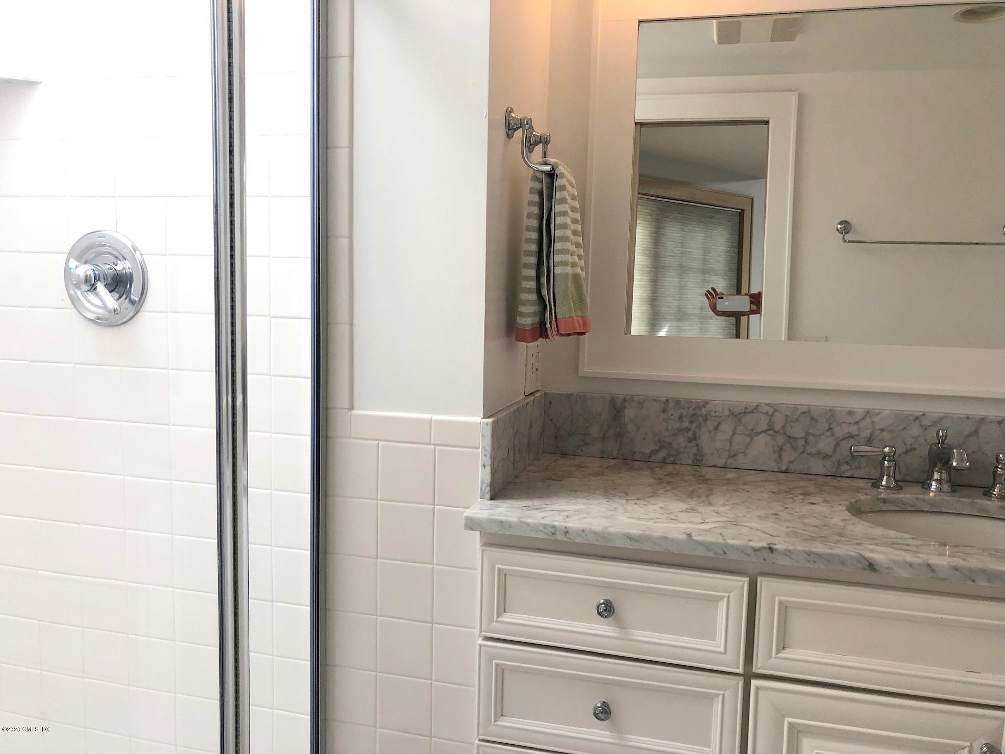 10 Lake Drive South, Unit SOUTH Riverside, CT 06878 - Photo 35 of 45 a bathroom with a granite countertop sink and a mirror