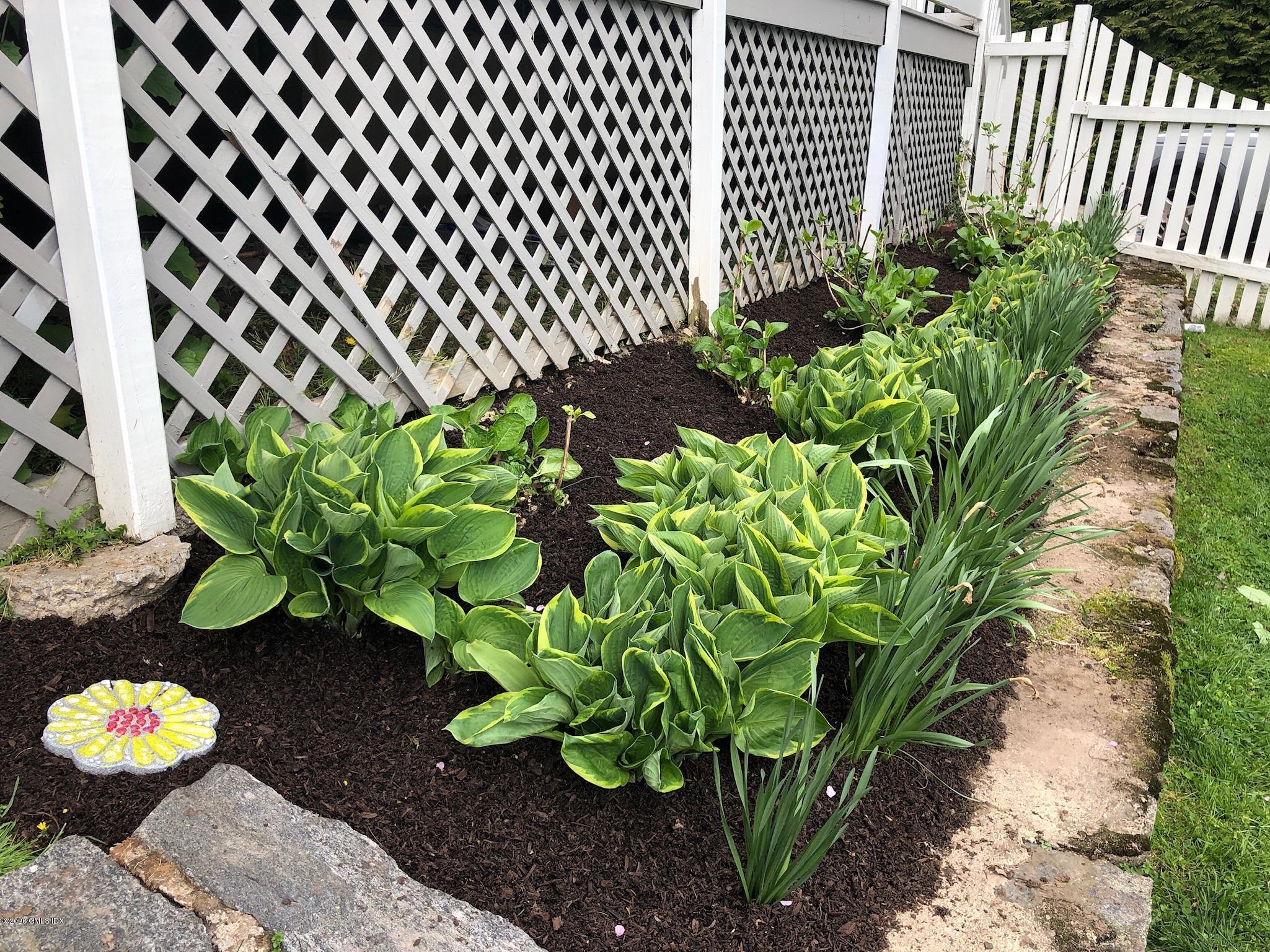 10 Lake Drive South, Unit SOUTH Riverside, CT 06878 - Photo 38 of 45 a vase with flowers in front of a garden