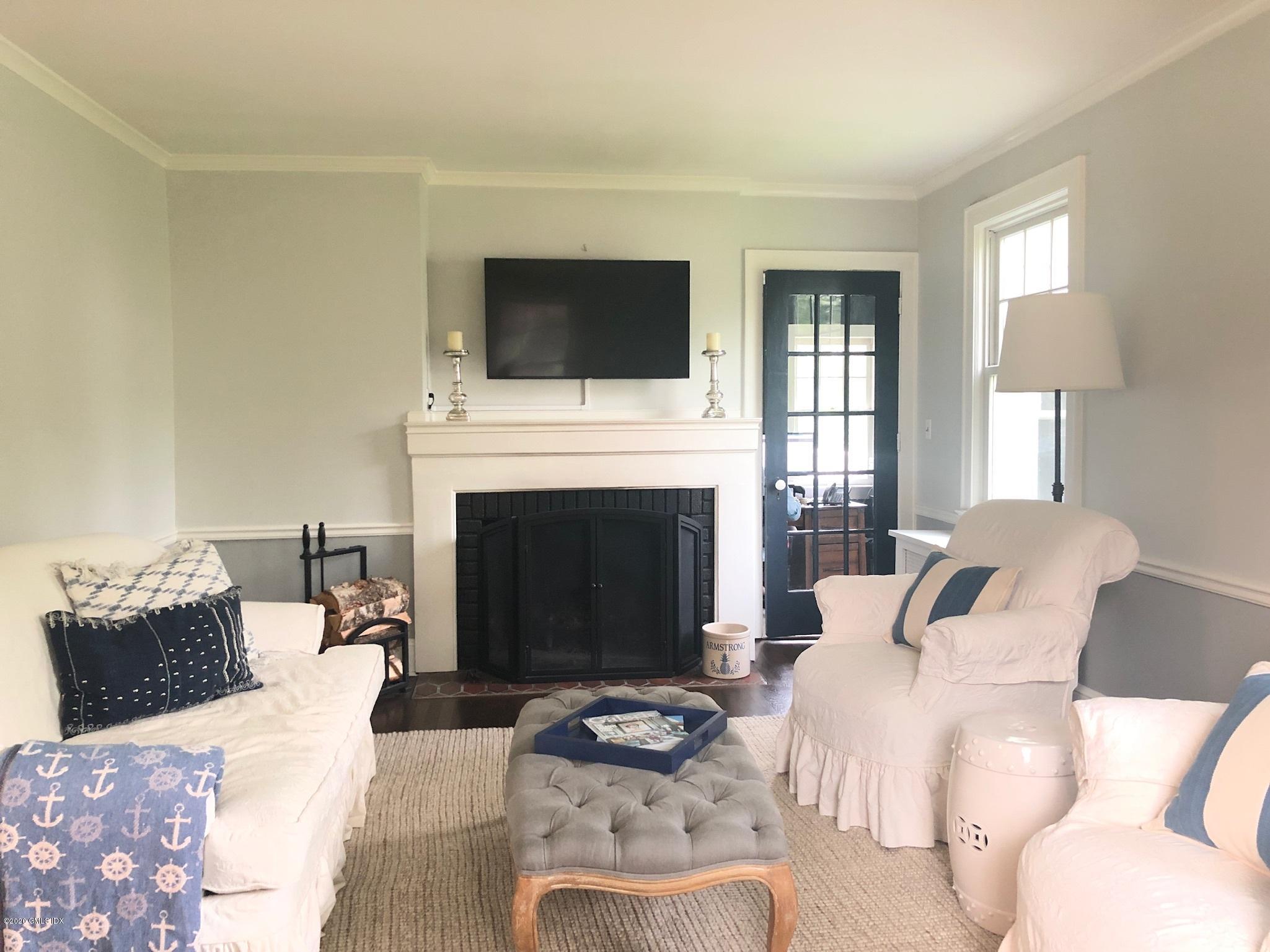 10 Lake Drive South, Unit SOUTH Riverside, CT 06878 - Photo 10 of 45 a living room with furniture a flat screen tv and a fireplace
