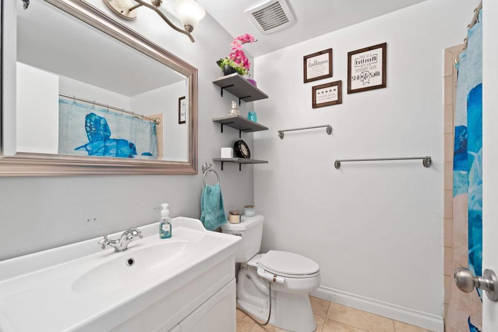 2461 Trace Road Spring Valley, CA 91978 - Photo 11 of 26 a bathroom with a sink mirror toilet and vanity