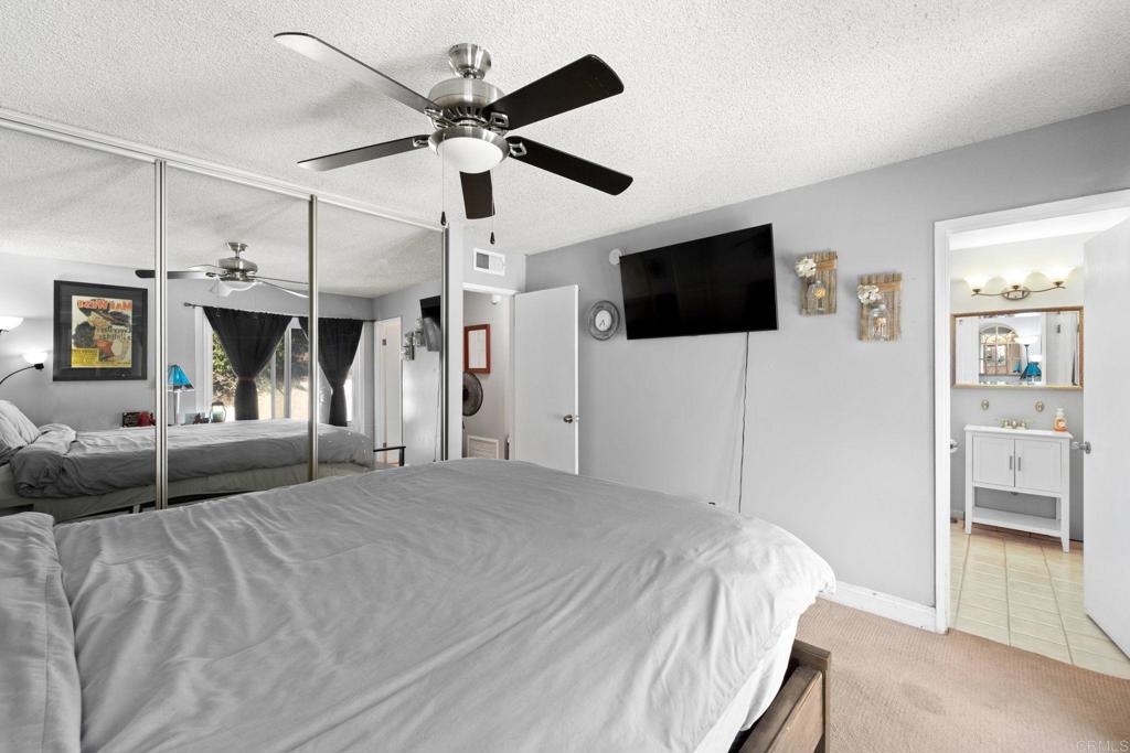 2461 Trace Road Spring Valley, CA 91978 - Photo 13 of 26 a spacious bedroom with a bed and a flat screen tv