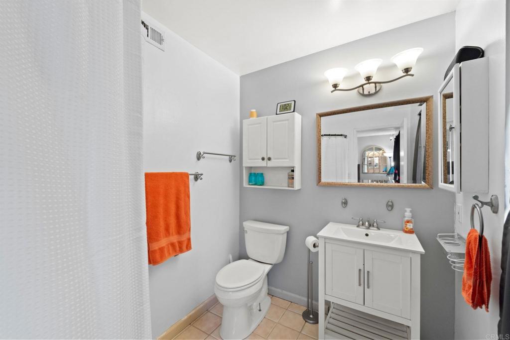 2461 Trace Road Spring Valley, CA 91978 - Photo 14 of 26 a bathroom with a sink a toilet and a mirror