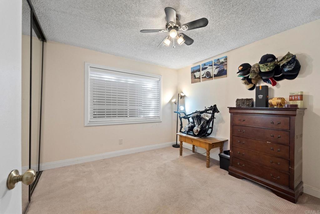 2461 Trace Road Spring Valley, CA 91978 - Photo 15 of 26 a bedroom with a bed and a chandelier