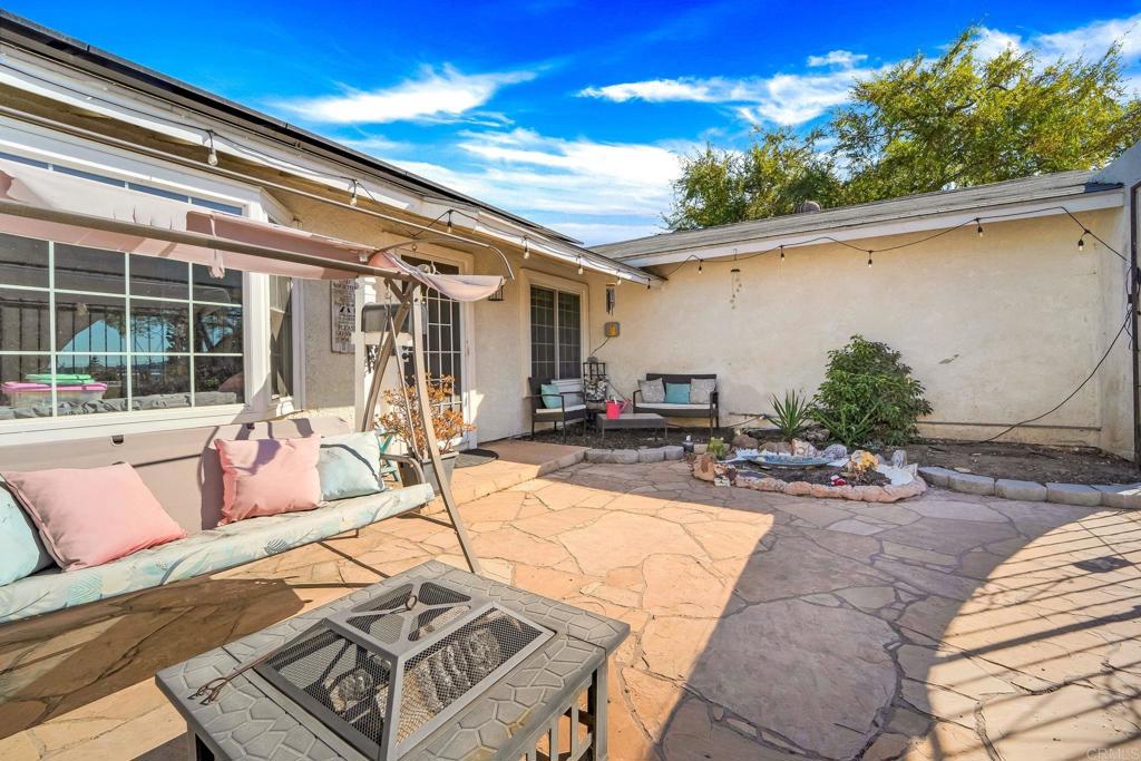 2461 Trace Road Spring Valley, CA 91978 - Photo 23 of 26 a view of a patio with couches table and chairs with potted plants
