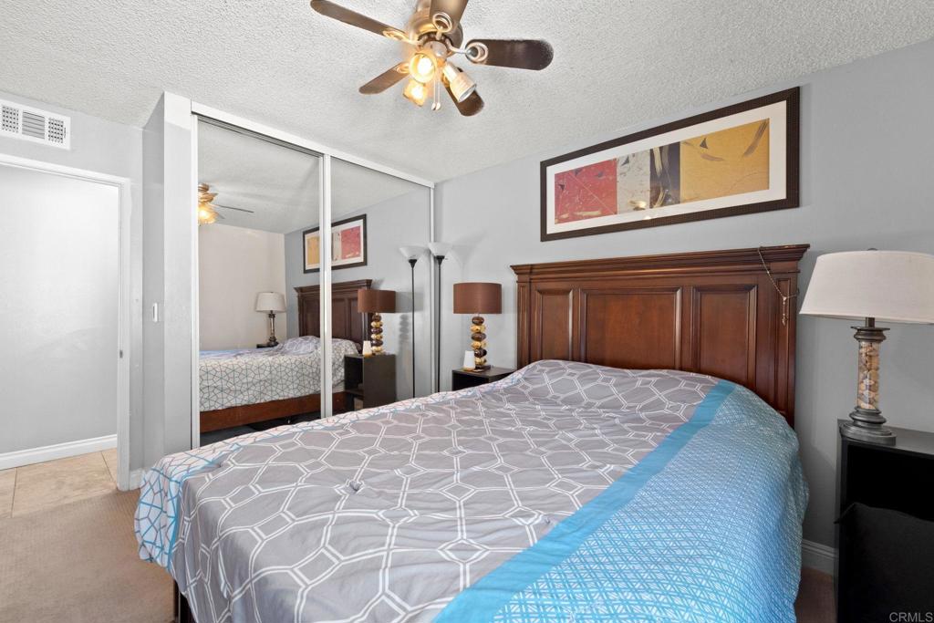 2461 Trace Road Spring Valley, CA 91978 - Photo 10 of 26 a bedroom with a large bed and a chandelier