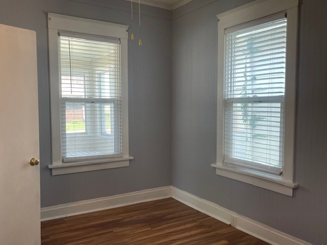 214 North 3rd Street Clinton, IA 52732 - Photo 8 of 11 a view of an empty room with wooden floor and a window