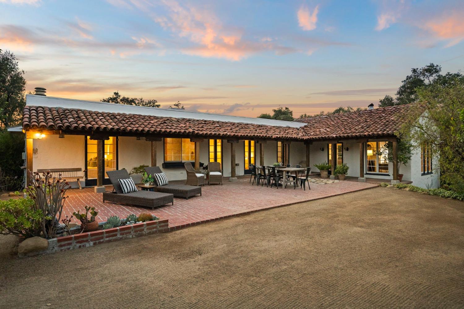 105 Foothill Road Ojai, CA 93023 - Photo 21 of 38 a view of a patio with table and chairs under an umbrella