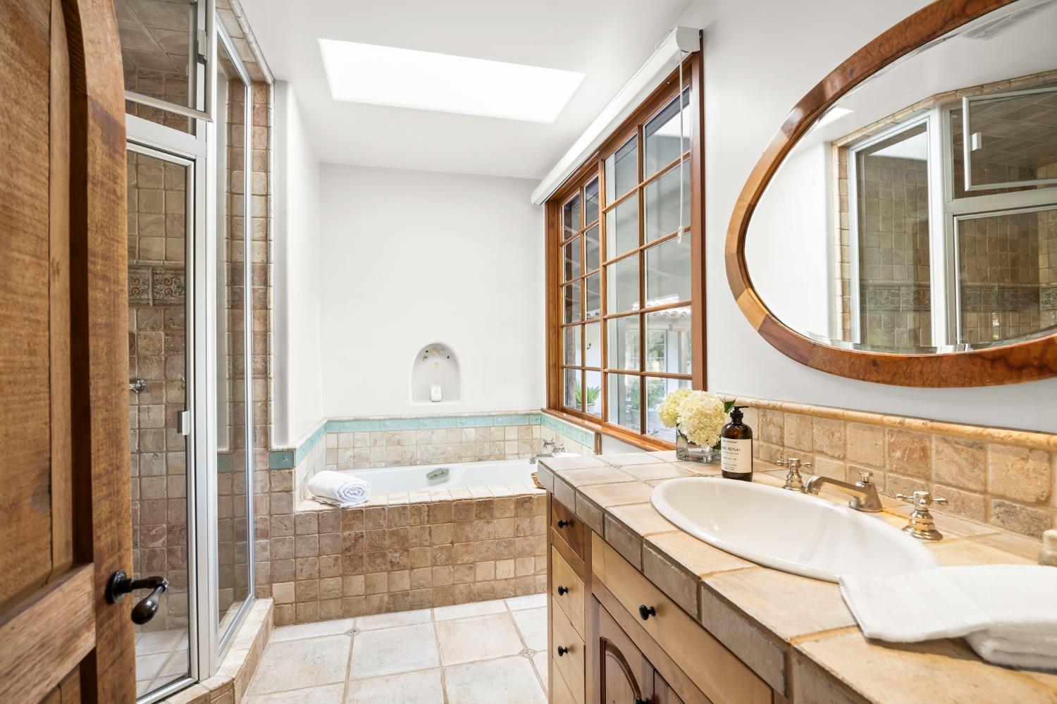 105 Foothill Road Ojai, CA 93023 - Photo 30 of 38 a bathroom with a granite countertop sink and a mirror