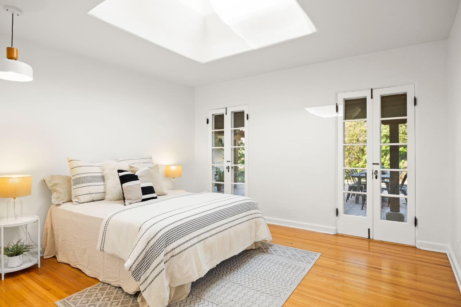 105 Foothill Road Ojai, CA 93023 - Photo 32 of 38 a bedroom with a bed and wooden floor