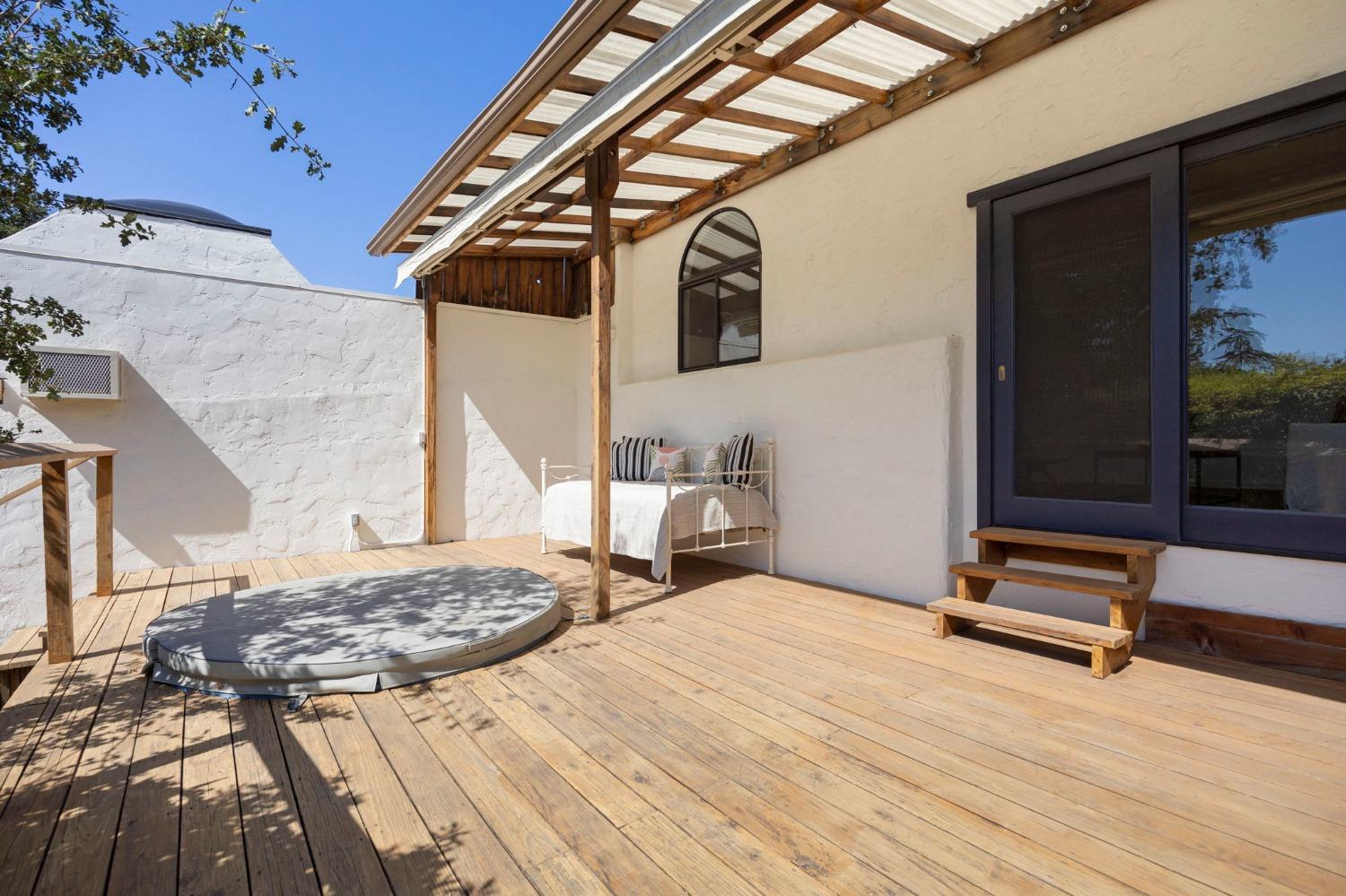 105 Foothill Road Ojai, CA 93023 - Photo 34 of 38 a bedroom with a bed and a wooden floor