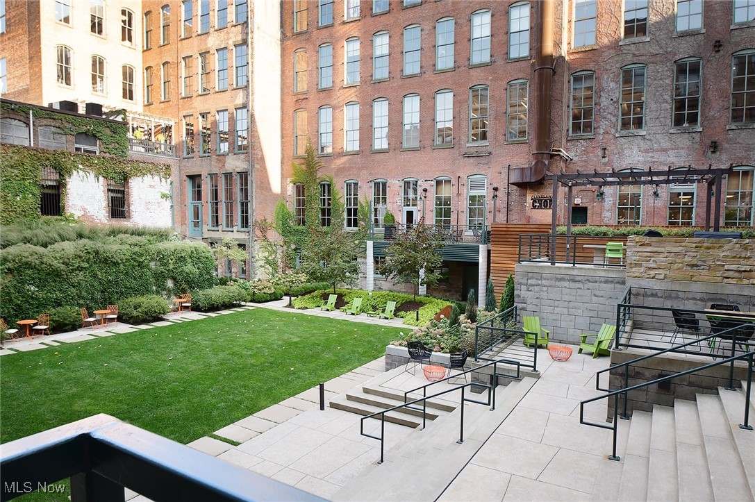 725 Johnson Court, Unit 220 Cleveland, OH 44113 - Photo 13 of 25 East courtyard featuring a large lawn, multiple seating areas and a pergola over an outdoor kitchen area with grills