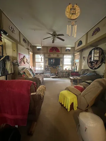 a living room with furniture a chandelier and a fireplace