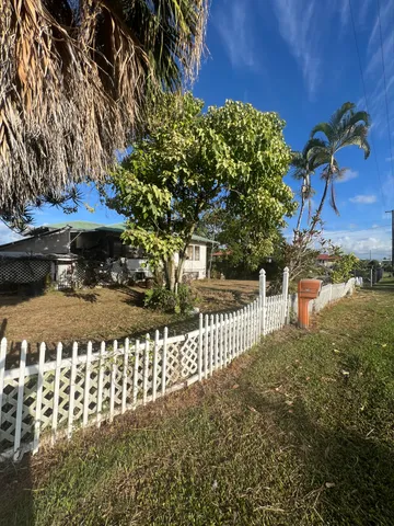 a view of a street with a bench in front of house
