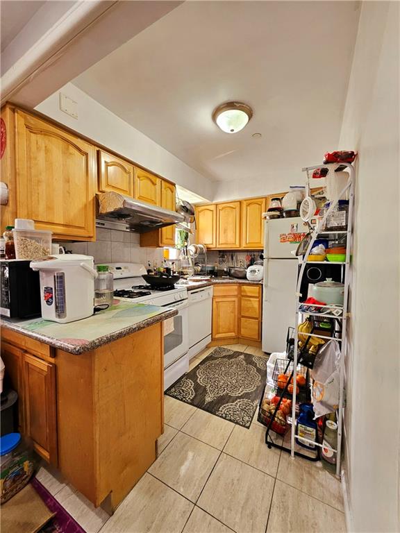 1820 73rd Street, Unit 1A Brooklyn, NY 11204 - Photo 13 of 20 a kitchen with a refrigerator and a stove top oven