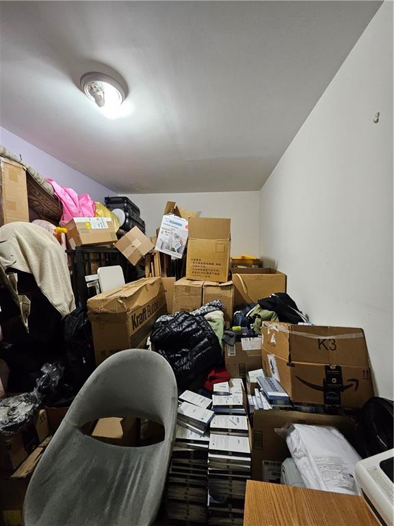 1820 73rd Street, Unit 1A Brooklyn, NY 11204 - Photo 15 of 20 a living room with lots of furniture and clothes