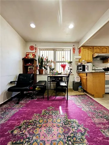 a living room with furniture a rug and a flat screen tv