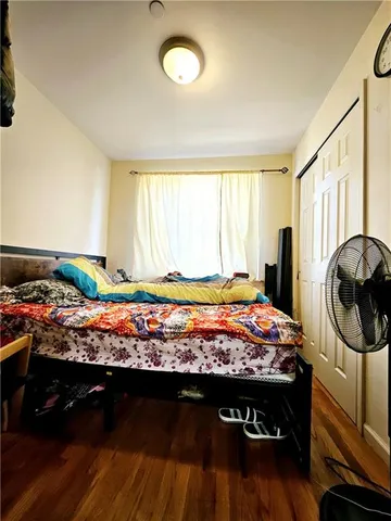 a bed sitting in a room next to a window