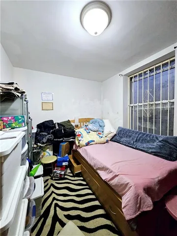 a bedroom with bed and a chandelier