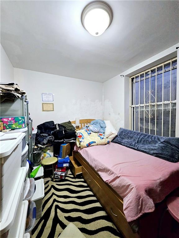 1820 73rd Street, Unit 1A Brooklyn, NY 11204 - Photo 8 of 20 a bedroom with bed and a chandelier