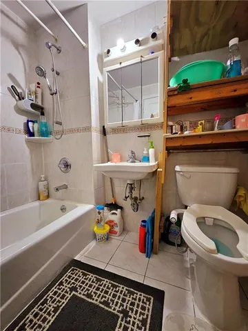 a bathroom with a sink a toilet and bathtub