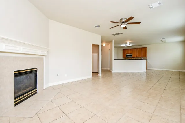 a view of an empty room and fire place