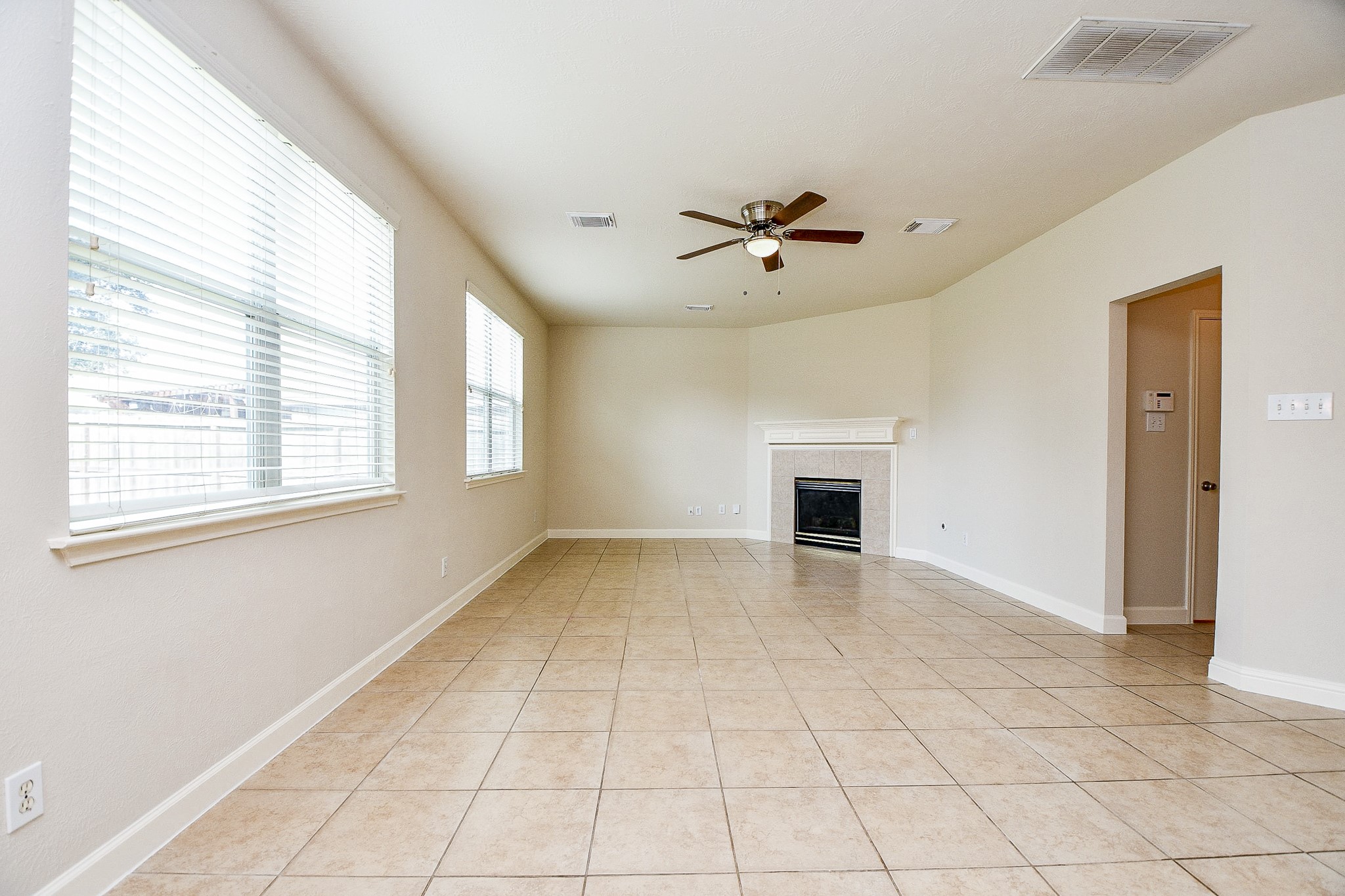 2707 Silk Tree Lane Katy, TX 77449 - Photo 16 of 31 a view of an empty room with a window and fireplace