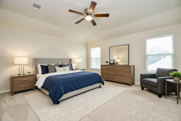 a bedroom with a bed a couch and a window