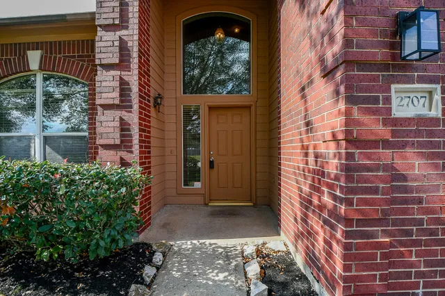 a view of a brick house with a large windows