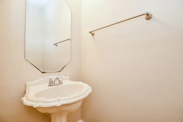 a bathroom with swimming pool and trees in the background
