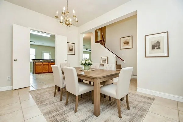a view of a dining room with furniture and chandelier