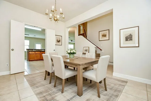 a view of a dining room with furniture and chandelier