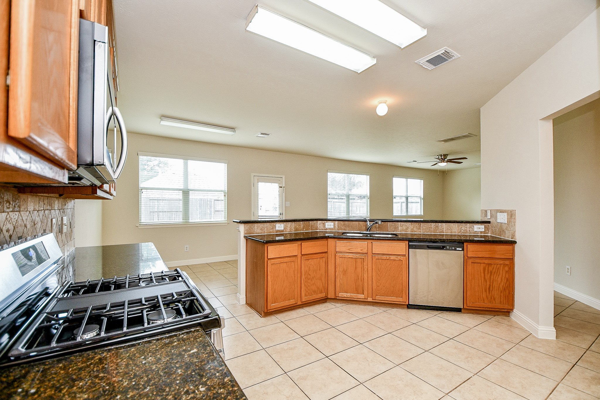 2707 Silk Tree Lane Katy, TX 77449 - Photo 10 of 31 a kitchen with stainless steel appliances granite countertop a stove a sink and a refrigerator