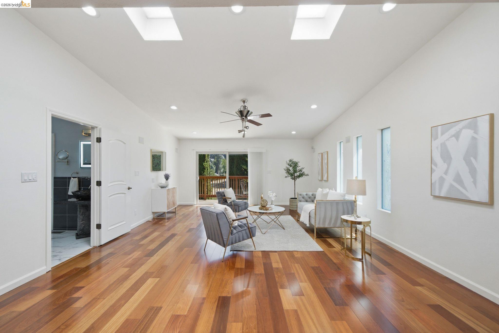 11133 Golf Links Road Oakland, CA 94605 - Photo 26 of 57 Spacious living area featuring rich wood-finish flooring, recessed lighting, and dual skylights