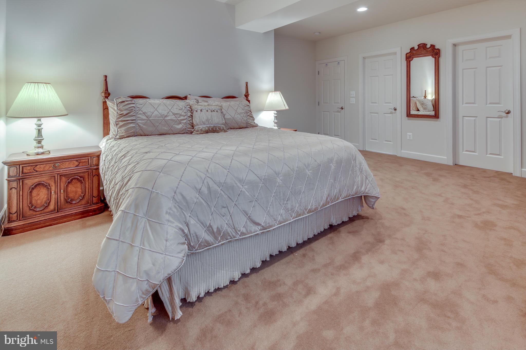 7706 Elmwood Road Fulton, MD 20759 - Photo 24 of 30 a bedroom with a bed and a lamp
