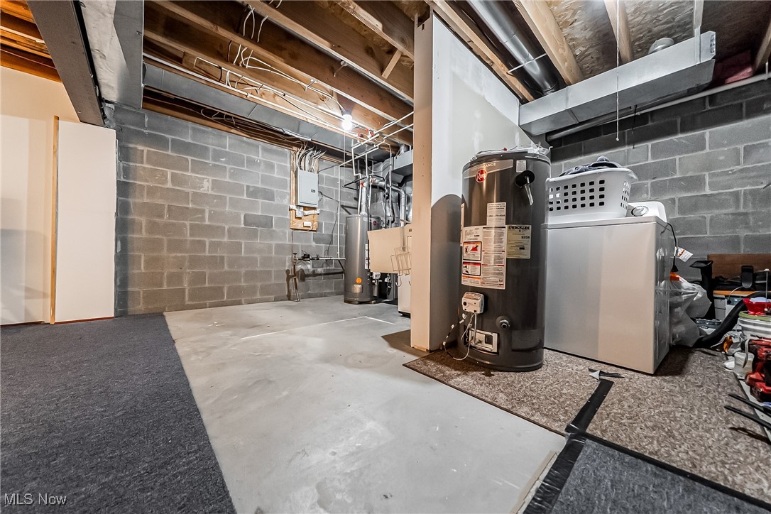 882 Overlook Ridge Drive Cleveland, OH 44109 - Photo 23 of 26 Unfinished basement featuring water heater and separate washer and dryer