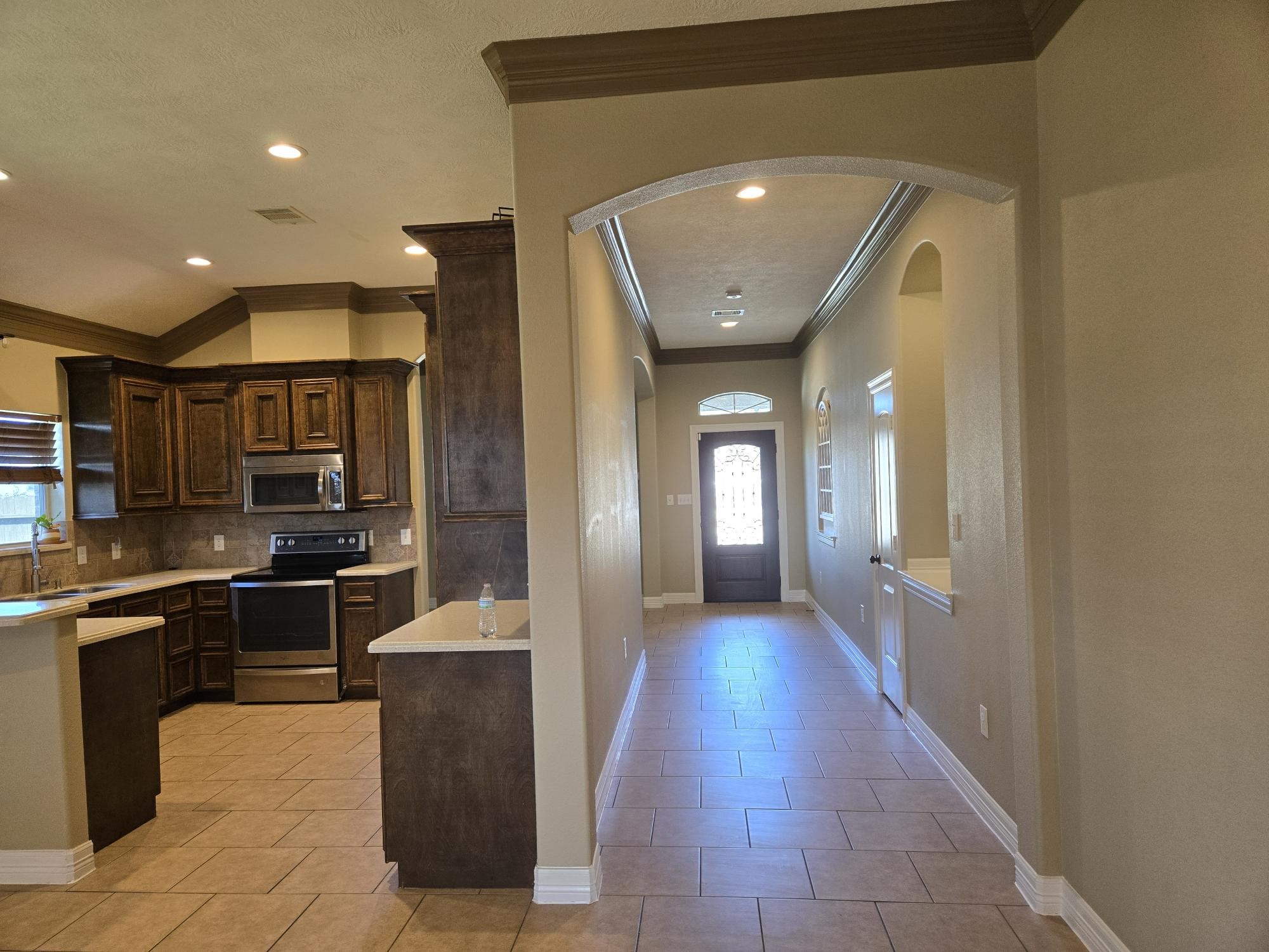 306 Masterson Street Arcola, TX 77583 - Photo 7 of 28 a hall with stainless steel appliances granite countertop a refrigerator and a sink