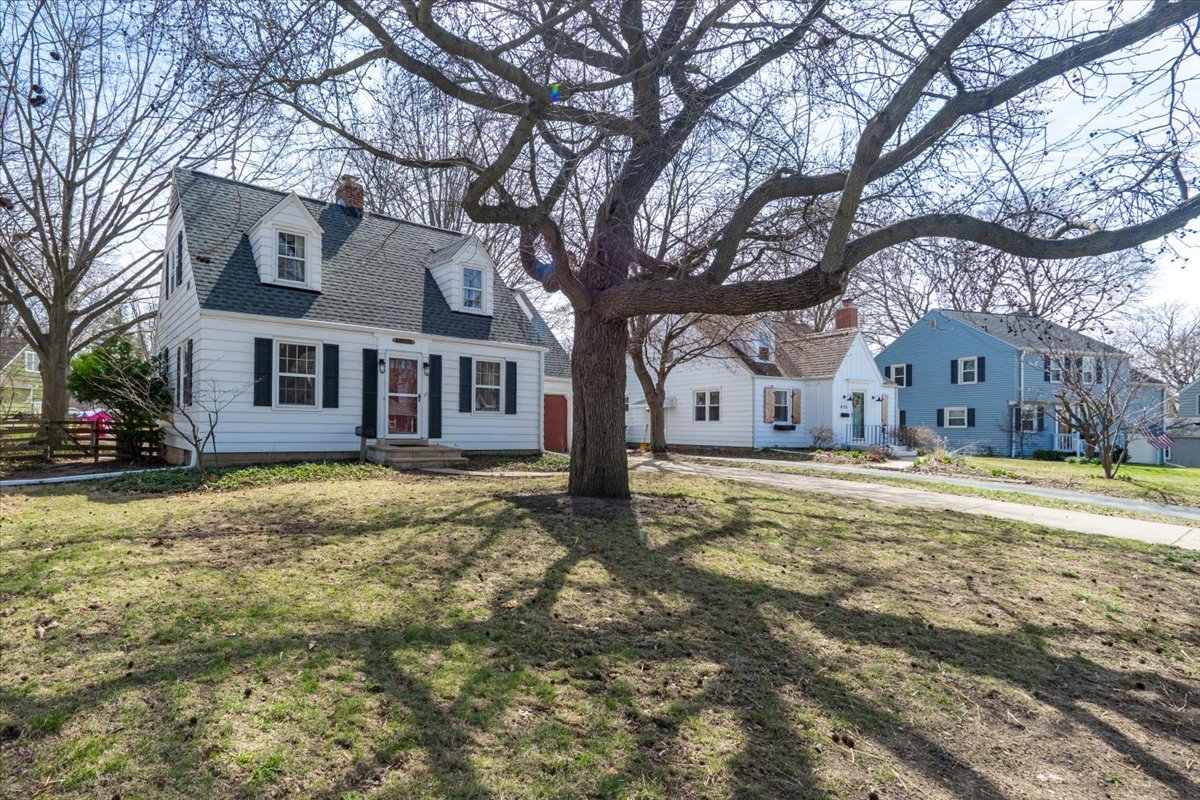 413 Grant Street Normal, IL 61761 - Photo 2 of 40 a view of a large house with large trees and a big yard