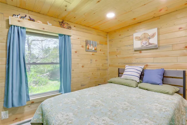 a bedroom with a large bed and a window