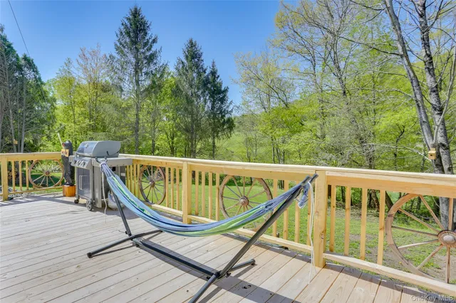 a view of a deck in backyard of house