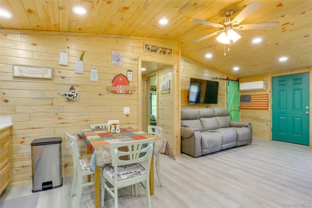 a dinning room with furniture and a flat screen tv