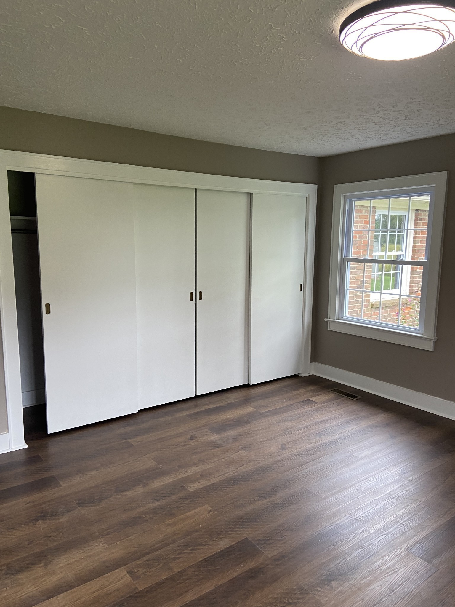 11495 Guthrie Road Guthrie, KY 42234 - Photo 30 of 43 an empty room with wooden floor and windows