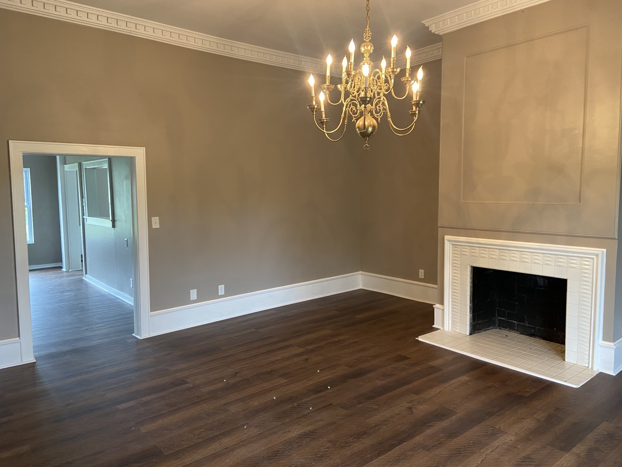 11495 Guthrie Road Guthrie, KY 42234 - Photo 10 of 43 a view of an empty room with wooden floor and a fireplace