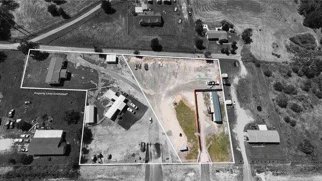 an aerial view of a house with a yard