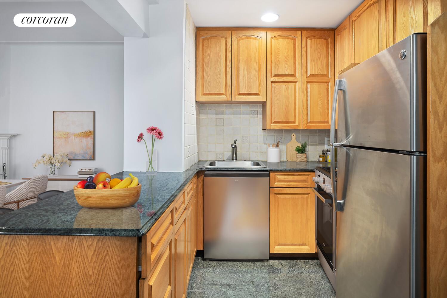 235 East 22nd Street, Unit 6P Manhattan, NY 10010 - Photo 3 of 5 a kitchen with stainless steel appliances granite countertop a refrigerator sink and cabinets