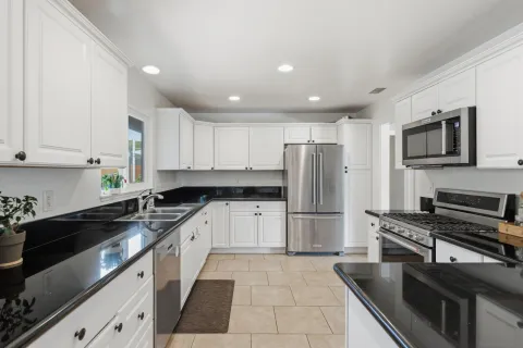 a kitchen with a sink a stove and refrigerator