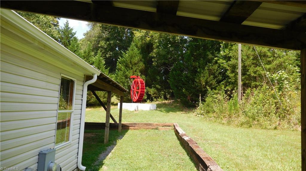 1334 White Rock Road Pinnacle, NC 27043 - Photo 12 of 27 Nicely landscaped. Beautiful Water Wheel in side yard.